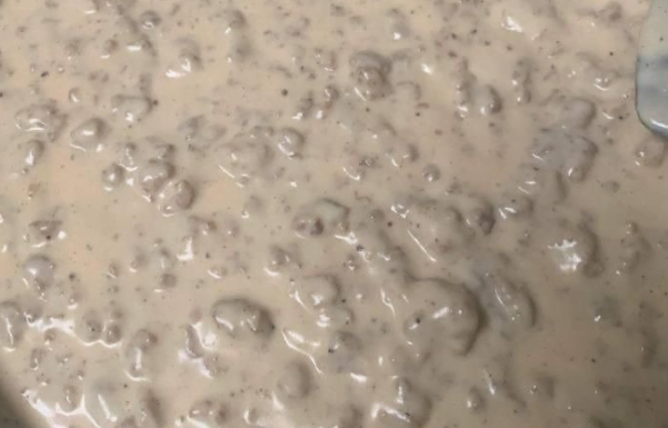 1-pound breakfast sausage, hot or mild 1/3 cup all-purpose flour 3 to 4 cups whole milk, more to taste 1/2 teaspoon seasoned salt 2 teaspoons freshly ground black pepper, more to taste 12 cooked biscuits, warmed, for serving