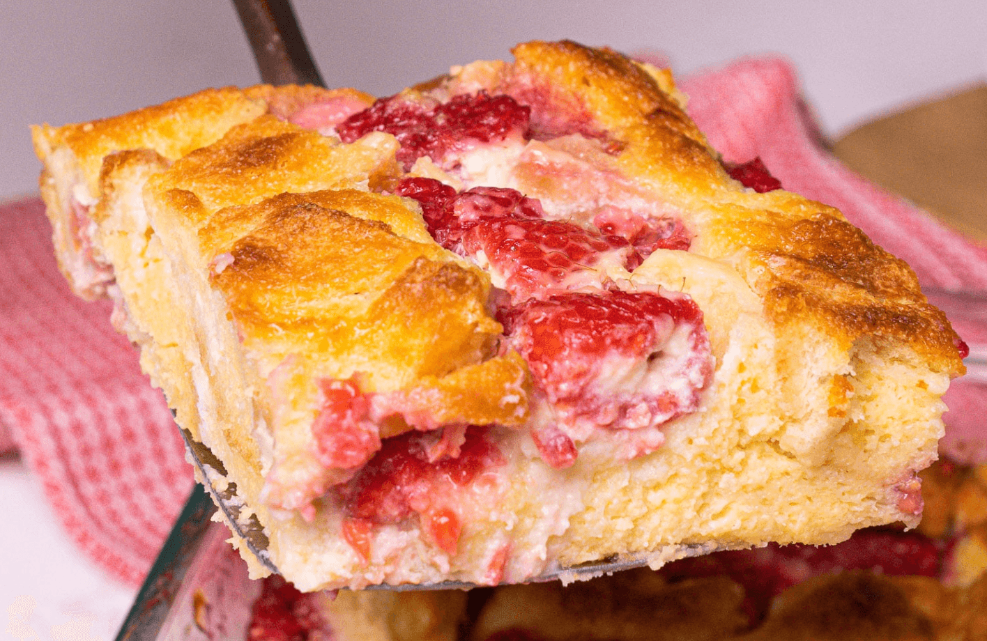 INGREDIENTS 1 large loaf white bread, cubed 1 (8 oz) package cream cheese, room temperature ½ cup sugar Zest of 1 lemon 2 teaspoons vanilla extract 2 ½ cups fresh raspberries 9 eggs 2 cups milk ⅓ cup sugar 1 teaspoon vanilla